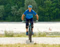 Correct

 The basic position: The legs are almost straight, the arms slightly bent. Your shoulders hover over the handlebars. In this position, you can see everything on the trail, save energy by keeping your legs straight, have enough pressure on the front wheel and can react to bumps with your bent arms.