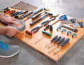 Firstly, lay out all the tools that you want to attach to the tool wall neatly on the OSB board. Make sure there is sufficient space between the individual parts.
