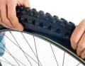 1. after a puncture, you must first completely loosen the bicycle tyre and press it into the rim well on one side. Only then can the tyre be levered outwards over the rim flange in the next step. 