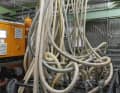 Before the granulate can be processed, the water must be removed from the material. This is done in large dryers. The granules are then transported to the injection moulding machines via the granulate station, an impenetrable network of pipes and lines.