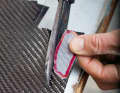 (2) Cutting patches Using a template, Jochen cuts some patches from the carbon fibre mats. Different ones are used depending on the location.