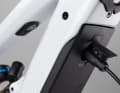The cable is plugged directly into the down tube for charging. A splash guard protects the charging port from dirt.