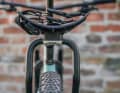 To ensure that the carrier is perfectly aligned, the clamps must be fitted to the seat struts at exactly the same height.