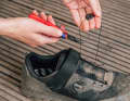 It is best to cut off the old laces with a small pair of pliers