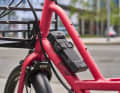 The revised SH bracket holds the lock by applying light pressure to the bars. The lock engages securely. An integrated compartment offers space for GPS trackers.