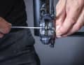 1 Remove the locking screw: Before you start replacing the brake pads, use a flat tool to push the brake pistons back as far as possible between the old brake pads. This will create space for the new, thicker pads. Now remove the retaining ring and then the retaining screw.