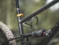 Due to the position of the shock, the mounting point for the bottle cage is under the top tube. Caution: Not every bottle cage will hold the bottle securely in place overhead.