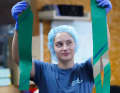 Laminating is a highly complex process that requires absolute precision. The employees wear surgical caps so that no hair gets into the moulds.