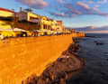 Stroll along the historic city walls of Alghero in the evening. The town, built in the Catalan-Gothic style, is one of the most beautiful places on the island
