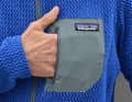 The Patagonia R1 Air does have a chest pocket. It won't fit a smartphone and the fabric is too stretchy for heavy items.