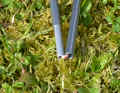 An elastic band holds the numerous elements of the central aluminium tent pole together.