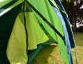The entrance door of the inner tent cannot be fixed in place, but it doesn't get in the way at the side. The dark-coloured strap regulates the tension, but is a little annoying if you want to push bags through it.