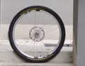 The front wheel has 28 spokes, more rim width and thinner spokes.