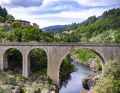Cyclists cross several old bridges on their way through the Dèpartement Ardèche.