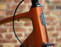 Deceptive: the head tube behind the proud emblem is not that long, only the stem and spacer give the upright position.