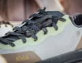 To prevent the laces from getting caught in the crank, they can be clamped under a small flap