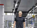 Laboratory employee Lars Funke carries two solid aluminium wheels to the test bench. New mountain bike compounds are first vulcanised onto road bike tyres. This eliminates the influence of the tread on the laboratory measurements.