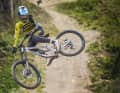 Accelerator: We engaged Worldcupper Stefan Garlicki to get a racer's opinion on each bike. Here Stefan dances over the step-up on the former World Cup track.