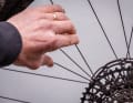 To check the spoke tension, press the spokes off in pairs. They should all have approximately the same tension.