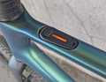 Minimalist and simple, but impractical, especially off-road, because you have to take your hand off the handlebars: Adjustment panel on the top tube.