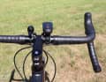 The cockpit is tidy; only the bell and a clip-on USB light are attached to the handlebars.