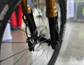 Upside down. With upside-down forks, the thicker stanchions are at the top and the thinner down tubes at the bottom.