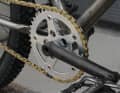 Not a piece of jewellery: the absolutely ridden BMX crank. Jewellery: the District 8 chainring with gold YBN chain.