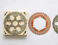 The components of the new disc. There is a copper disc between the two stainless steel discs for improved heat conduction.