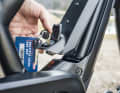 The battery is concealed under an aluminium cover secured with a key.