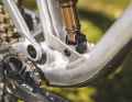 The bike achieves the shorter suspension travel with the help of a shorter shock and an adapter on the lower shock mount.