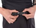 The waistband is equipped with silicone grippers and a moto buckle for precise adjustment.