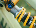 If you carefully loosen the small plastic screw with a screwdriver, you can adjust the spring preload by hand.