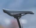 The saddle is very short. Ergo: On steep climbs, you can't slide very far forwards on the nose of the saddle.