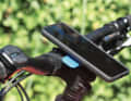 QuadLock: A slight twist of the wrist and the custom-fit case with the smartphone locks securely into the holder. The mechanism sits in the base and the phone is released at the touch of a button. Custom-fit cases are available for many popular phones.