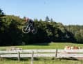 Gabriel is riding his Canyon Grizl over the jumps at the Samerberg Bike Park on Lake Chiemsee.