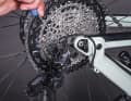 2: Distance: Rear derailleur and sprocket One of the prerequisites for optimum gear shifting function is the correct distance between the rear derailleur and sprocket. This is set using the wrap screw near the derailleur hanger. The distance varies depending on the model. Check the operating instructions!
