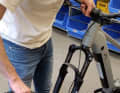 The front wheel can be quickly fitted into the fork and secured with the thru-axle.
