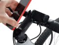 The compact silicone holder can be operated with one hand and encloses smartphones of different sizes
