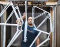 The in-house powder coating shop makes dozens of colours possible. Anthony Febrissy is directing a few freshly primed frames from the oven to cool down. Two men in the company are specialists for the colourful, durable surfaces.