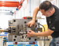 A technician regularly checks the mould and its many moving parts.