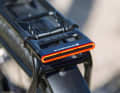 A rear light with brake light function integrated into the pannier rack.