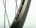 Asymmetrical: On the rear wheel, the spoke holes in the rim are moved to the left in favour of more even spoke tension.