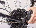 If the bike has derailleur gears, shift to the smallest sprocket and push the rear derailleur all the way back so that the axle is exposed in the dropout.