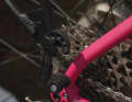 The pannier rack is attached to the plastic mounting on the left and right of the rear wheel hub, ...