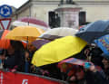 Typical picture of the Giro 2023. Riders and spectators depend on good weather protection. Giro d'Italia, 5th stage, 10 May 2023.