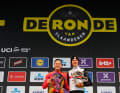 Honour to whom honour is due. Lotte Kopecky and Tadej Pogacar at the victory ceremony of the Tour of Flanders, 2 April 2023.