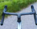 The new handlebars also move the grip position further forwards and downwards. They are no longer adjustable in width.