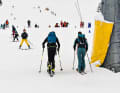 Reverse thrust: While the masses of skiers plunge down into the valley, Antonia Niedermaier (right) sets off for training.