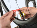 Aerodynamic bladed spokes must be held in place when centring so that they do not twist. The spoke holder from DT Swiss has proven its worth. 