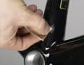 Sand the area with a fine sandpaper in a narrow area and very carefully. Wipe off the sanding dust.